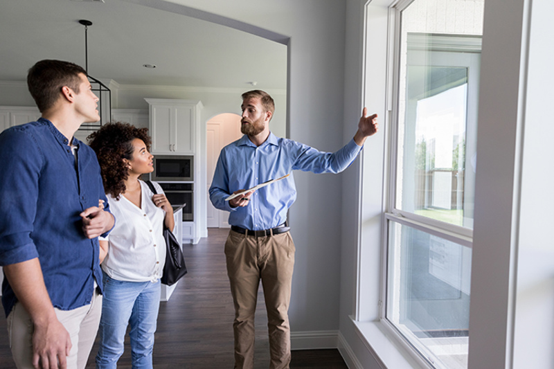 3 Tips to Prevent an AC Breakdown During a Heat Wave. Tech with couple.