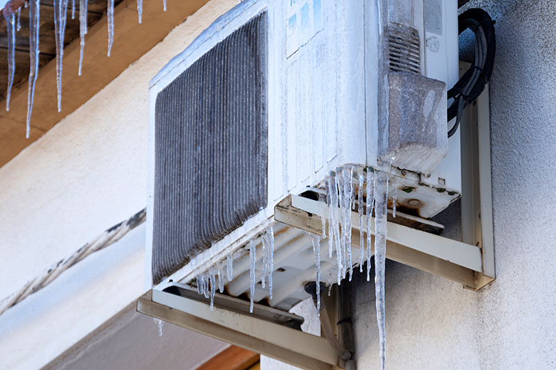 Why Is My Heat Pump Freezing Up? A heat pump covered in ice.