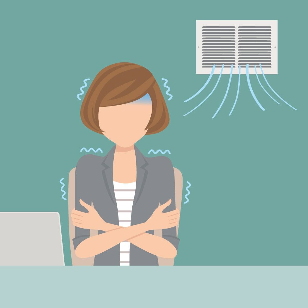 Cartoon of a woman freezing cold because cold air is blowing out of her vents.