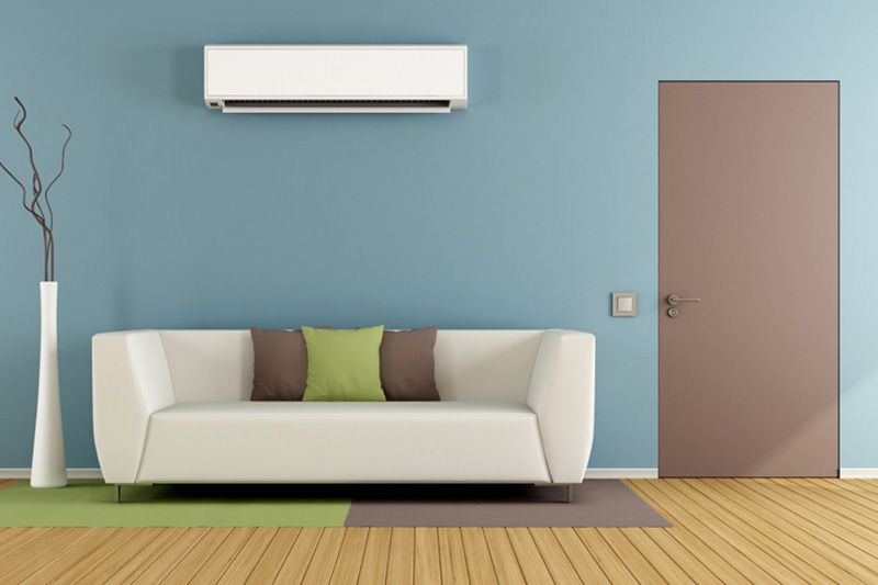 Image of a ductless system above a couch. Why Ductless Is the Way to Go.